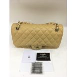 A Chanel beige quilted handbag with chain strap.Approx 18x30cm wide