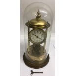 A gilt metal pillar clock with floral painted dial under glass dome.Approx 45cm