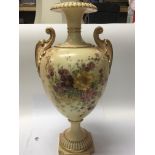 A large Royal Worcester vase hand painted with flowers and with gilt scroll handles. Hight 42cm