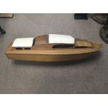 A large wooden model of a speedboat with electric motors and brass propeller and rudder. Length