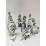 A collection of eight Spanish porcelain figurines including two Lladro and four Nao