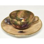 A Quality miniature hand painted Worcester cup and saucer the decoration with fruits on a rustic