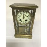 A four glass mantle clock the dial with Arabic numerals and visible mercury pendulum