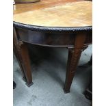 A mahogany dining table with two d end sections on turned legs