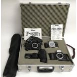 A camera case containing Nikon F-401, F90 and F-401 slr camera bodies plus lens and tripod