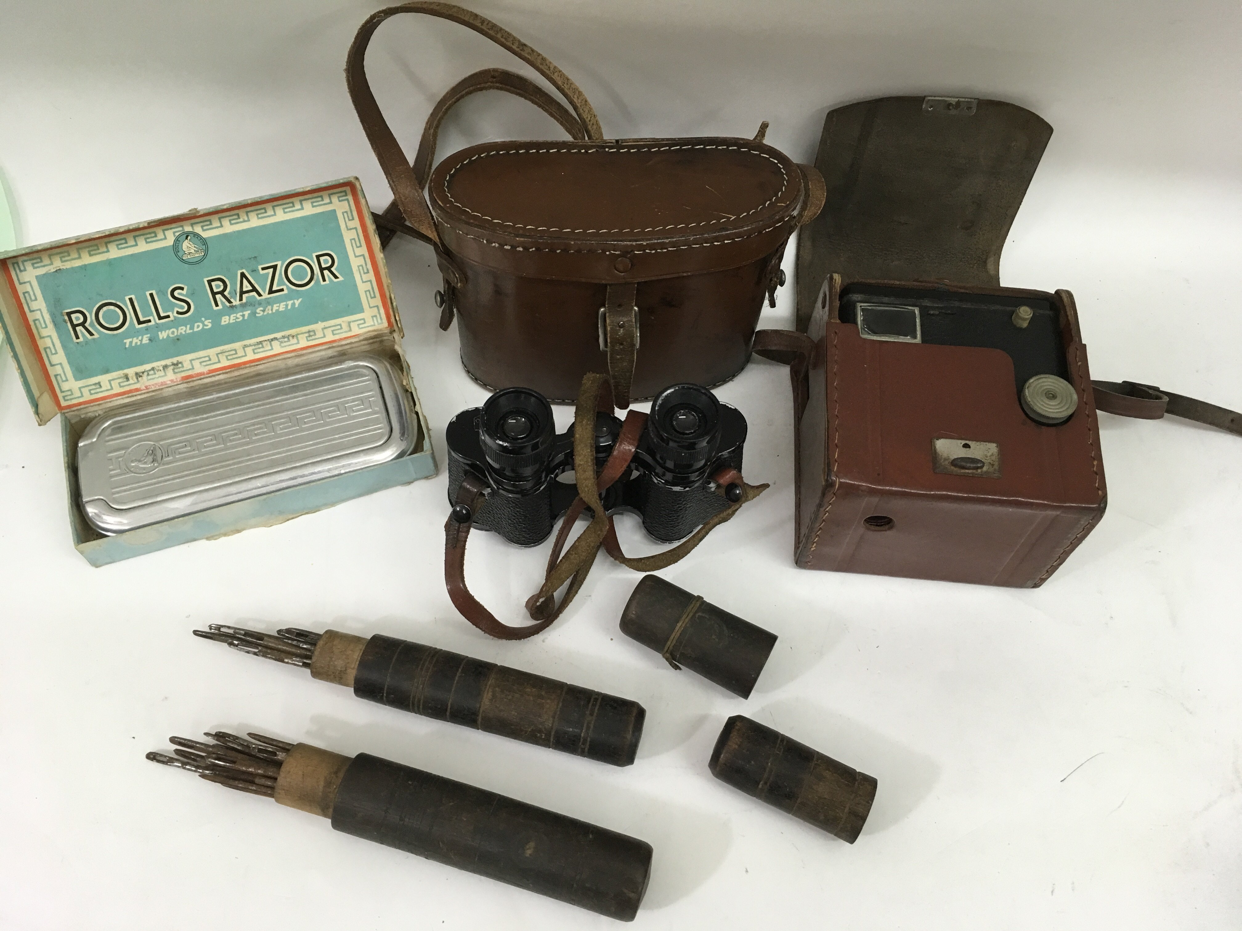 A pair of old wooden cased sailmaker's needles, box brownie camera, and Deraisme binoculars