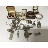A collection of silver jewellery including charm bracelet ingots and rings