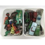 Two plastic tubs containing playworn die cast vehicles.