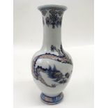 A small Chinese porcelain vase painted in red and blue with a three claw dragon.Approx 20cm, six