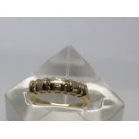 An 18ct gold ring set with alternating baguette cut diamonds.Approx V/W, 4,5g