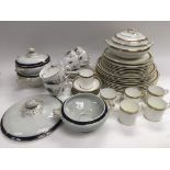 A collection of ceramic tableware comprising coffee cups, serving dishes etc.