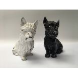 A pair of painted black and white cast metal Scotch Whisky dogs, approx 20cm.