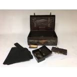 A small leather case by Stookdales of London containing oddments to include various spectacles, an