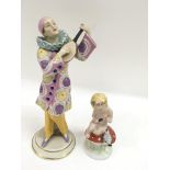 A large Royal Dux figure of a Harlequin with another of a cherub on a toadstool.Loss to end of