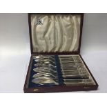 A cased set of silver plated continental fish knifes and folks in a fitted case.