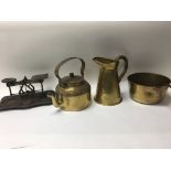 A group of brass items to include a Victorian saucepan, jug, swing handles kettle and a set of
