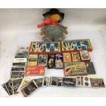 A small box containing vintage Panini Motor racing and Classic Car stickers, Top Trump cards, a