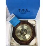 A boxed Garrard & Co circular barometer.