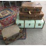 A vintage travelling trunk, two leather suitcases and one other canvas case.