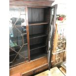 A mahogany bookcase cupboard the pair of glazed doors above a pair of cupboards doors on bracket