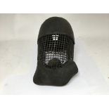 A very unusual antique leather and woven metal fencing or sparring helmet.