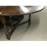 An oak drop leaf table with a set of ladder back dining chairs - NO RESERVE