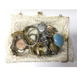 A ladies purse containing a collection of wristwatches, to include examples by Delco, Timex and