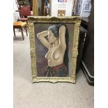 A gilt framed oil on canvas depicting a half nude lady signed to the bottom left. Frame measures