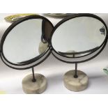 A pair of modern design table mirrors with circular marble bases bevelled edge. (2) diameter 30cm.