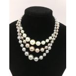 A modern three stand coloured pearl necklace