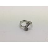 An 18ct white gold ring set with six diamonds in the form of two petals, approx 3g and approx size