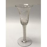 A wine glass the trumpet bowl wheel etched with grape vines, with opaque twist stems. Height 15.5cm