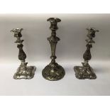 A pair of silver plated candlesticks, and one larger metal candlestick with a round base.