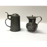 A pewter lidded tankard and a Chinese pewter mounted lidded jug with applied pewter dragons around