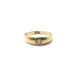 An 18ct gold ring set with a central diamond, gypsy ring style. Total weight approx 4 grams, ring