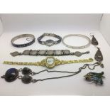 A collection of odd jewellery items comprising a coin bracelet, two silver bangles, wristwatch etc.