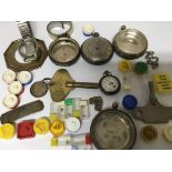 A small collection of watch parts and silver watch cases