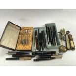 A collection of vintage pens, Meerschaum style cigarette holder, silver plated spoons etc.