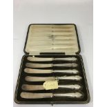 A cased set of Sheffield silver butter knives