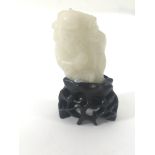 A small, carved white jade figure of Chinese elder