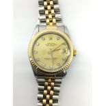 A midi Rolex Datejust wristwatch. The gold dial is decorated with square diamond numerals and a