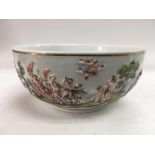 An antique Naples bowl decorated in relief and depicting scantily clad figures by the sea, approx