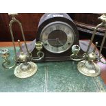 A pair of brass classical candle sticks and a oak mantle clock