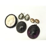 A collection of cameo brooches and two pairs of ea