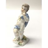 A 19th century Meissen figure of a putti on a naturalistic base. Height 11cm. No damage or