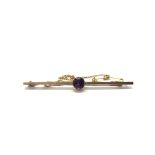 A 9ct gold bar brooch set with a central purple stone. Total weight approx 3.3 grams.