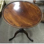 A George III occasional table on turned, pedestal tripod foot.Approx 50x65cm high