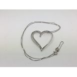 An 18ct white gold diamond set heart shaped pendan