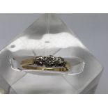 A 22ct gold ring set with three diamonds