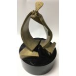 An Italian, modernist sculpture of an abstract figure by D.Delo.Patinated brass mounted on solid